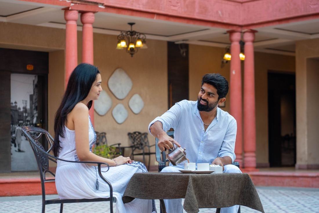 Couple at breakfast in a heritage hotel courtyard